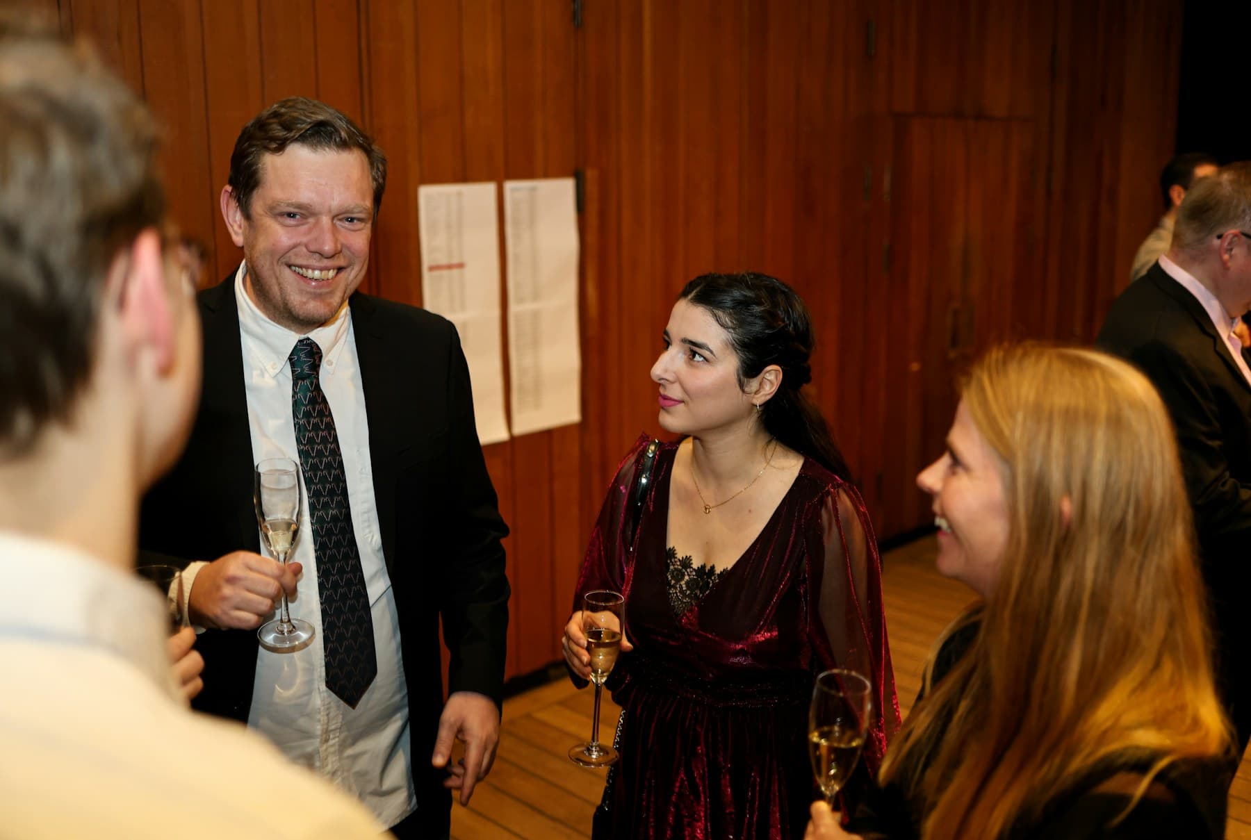 Guests holding champagne at a polished private event